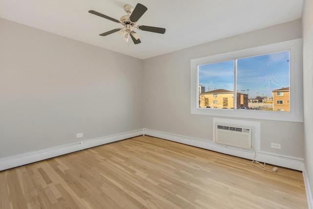 empty room featuring baseboards, a wall mounted AC, ceiling fan, and wood finished floors