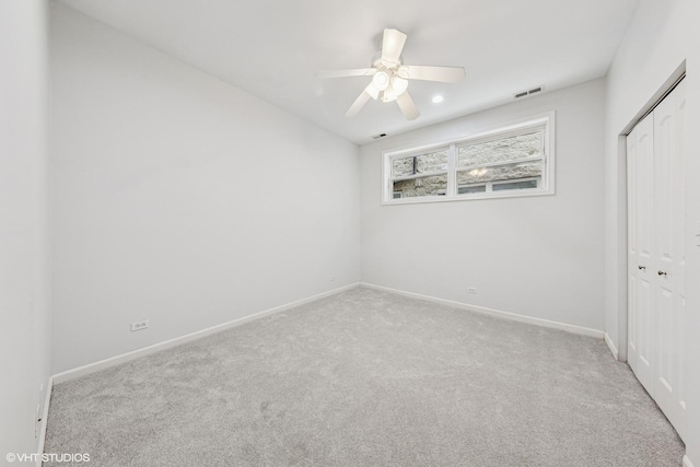 unfurnished bedroom featuring a closet, carpet flooring, baseboards, visible vents, and ceiling fan