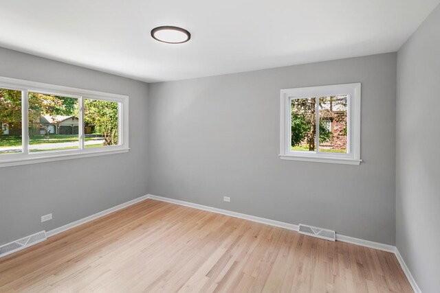empty room featuring visible vents and baseboards