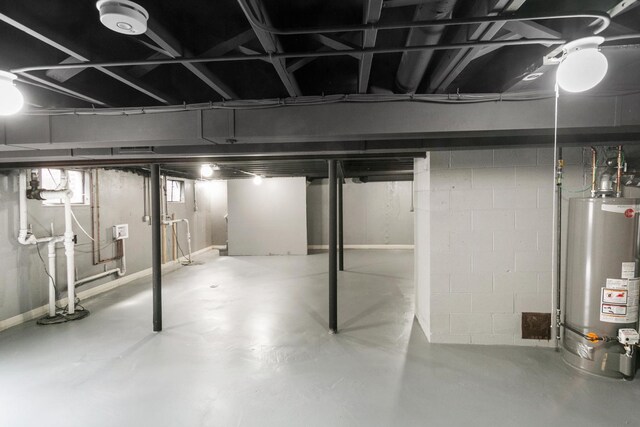 unfinished below grade area with heating unit and gas water heater