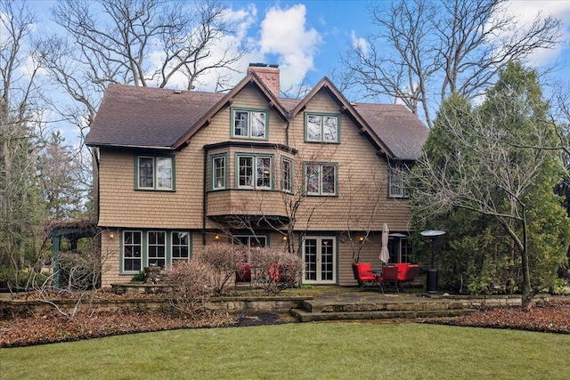 215 Prospect Ave, Highland Park, IL 60035 - back of house with a shingled roof, a patio, a chimney, and a yard