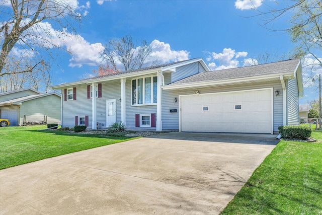 1618 Carolina Dr, Rantoul, IL 61866 - split foyer home featuring concrete driveway, a garage, and a front lawn