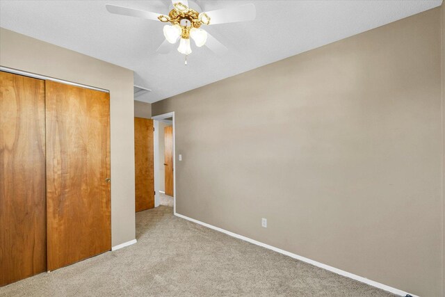 1618 Carolina Dr, Rantoul, IL 61866 - unfurnished bedroom with ceiling fan, carpet, a textured ceiling, a closet, and baseboards