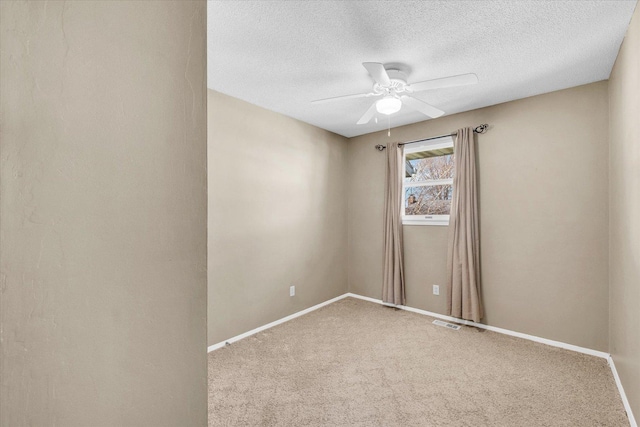 1618 Carolina Dr, Rantoul, IL 61866 - carpeted empty room with a textured ceiling, ceiling fan, baseboards, and visible vents