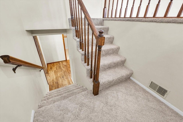 1618 Carolina Dr, Rantoul, IL 61866 - staircase featuring carpet, visible vents, and baseboards