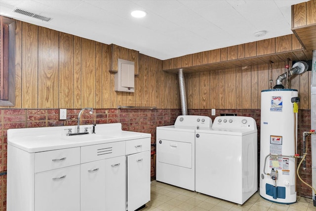 1618 Carolina Dr, Rantoul, IL 61866 - washroom with gas water heater, visible vents, a sink, washer and dryer, and cabinet space