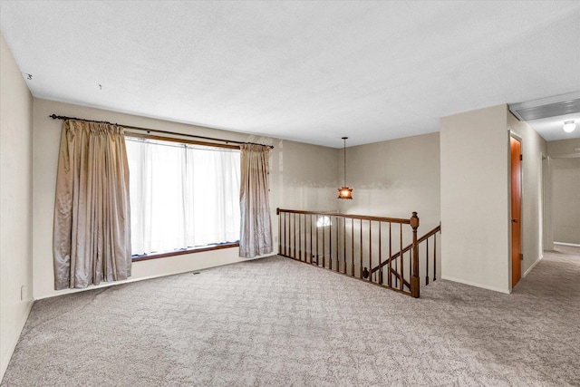 1618 Carolina Dr, Rantoul, IL 61866 - spare room featuring carpet floors and a textured ceiling