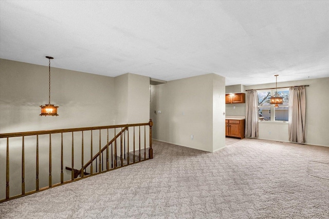 1618 Carolina Dr, Rantoul, IL 61866 - empty room featuring a chandelier, a textured ceiling, and light colored carpet