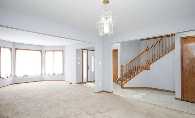 unfurnished living room with carpet floors, stairway, a chandelier, and baseboards