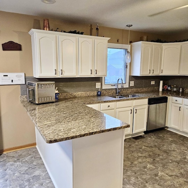 kitchen with stainless steel dishwasher, a sink, a peninsula, and white cabinetry
