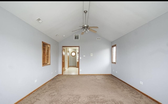 unfurnished room featuring a ceiling fan, baseboards, vaulted ceiling, and light colored carpet