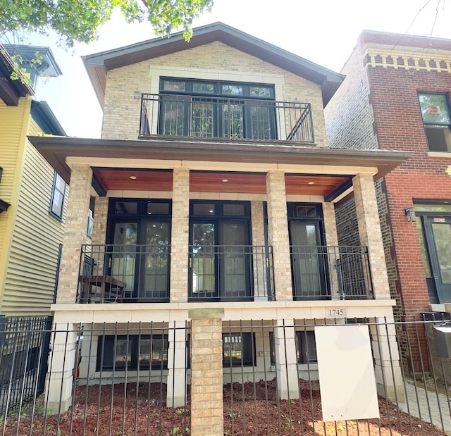 1745 W Cornelia Ave, Chicago, IL 60657 - rear view of property with a balcony, a porch, and brick siding