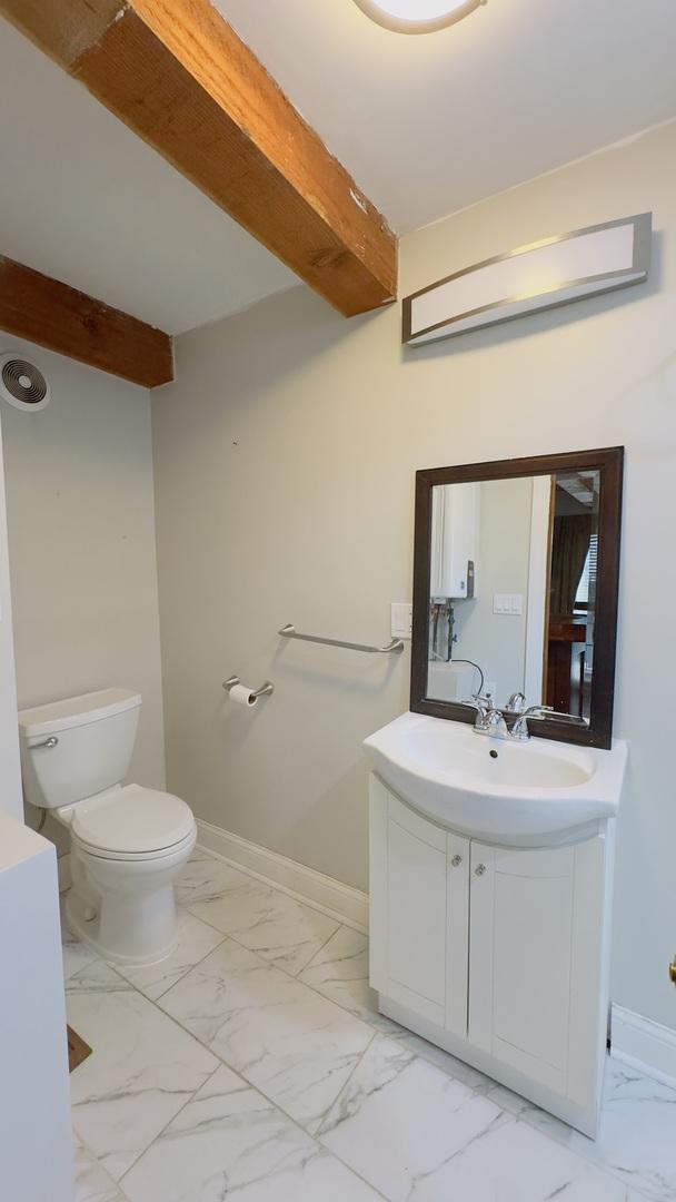 1745 W Cornelia Ave, Chicago, IL 60657 - bathroom with marble look tiles and vanity