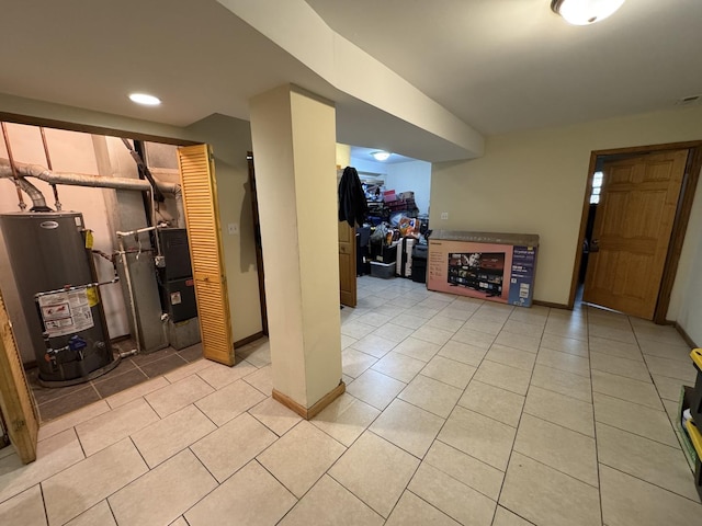 5014 S Prairie Ave Unit 1, Chicago, IL 60615 - finished basement with gas water heater, light tile patterned flooring, baseboards, and recessed lighting