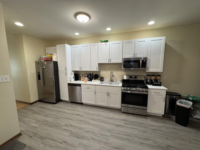 5014 S Prairie Ave Unit 1, Chicago, IL 60615 - kitchen with stainless steel appliances, a sink, light countertops, white cabinets, and recessed lighting