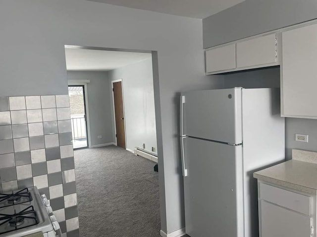 kitchen featuring white cabinets, light countertops, carpet floors, freestanding refrigerator, and a baseboard radiator