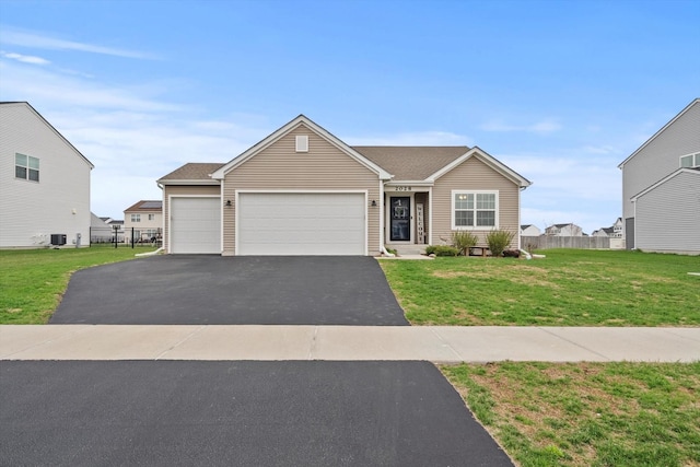 view of front of property with aphalt driveway, a garage, fence, and a front yard