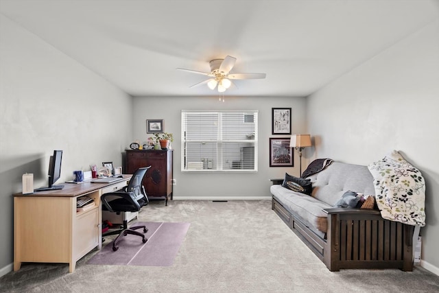 office area featuring baseboards, ceiling fan, and light carpet