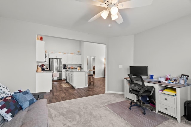 office area featuring baseboards, dark colored carpet, and ceiling fan