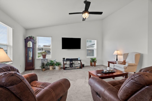 carpeted living room with baseboards, vaulted ceiling, and a ceiling fan