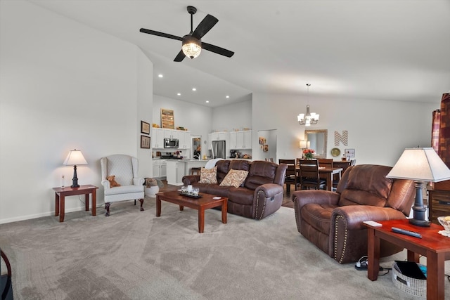 living room with high vaulted ceiling, baseboards, recessed lighting, light carpet, and ceiling fan with notable chandelier