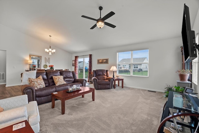 living room featuring visible vents, carpet, baseboards, ceiling fan with notable chandelier, and vaulted ceiling