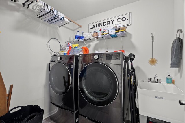 laundry room with independent washer and dryer, laundry area, and a sink
