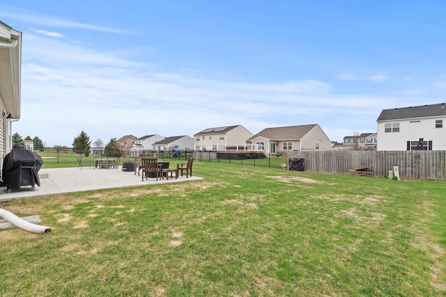view of yard with a fenced backyard, a residential view, and a patio