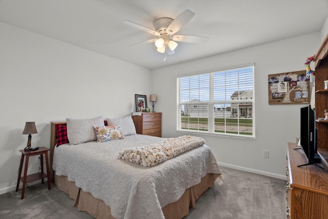 carpeted bedroom featuring a ceiling fan and baseboards