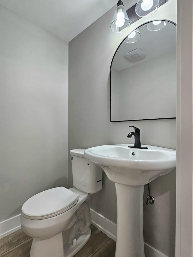 919 Dartmouth Ave, Matteson, IL 60443 - half bath with baseboards, wood finished floors, and toilet