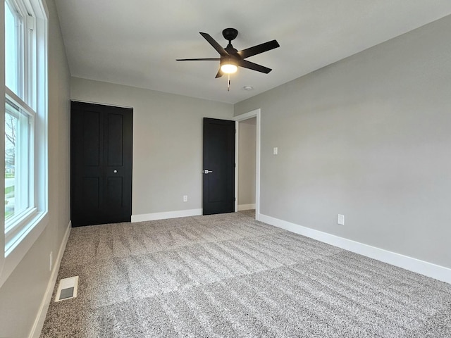 919 Dartmouth Ave, Matteson, IL 60443 - unfurnished bedroom featuring baseboards, carpet floors, visible vents, and a ceiling fan