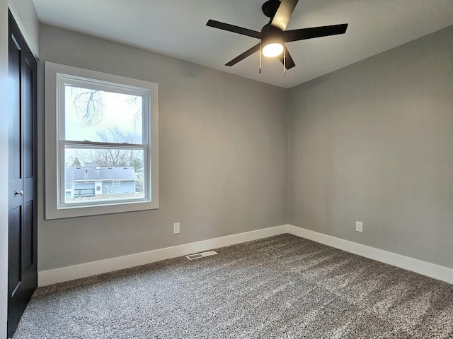 919 Dartmouth Ave, Matteson, IL 60443 - unfurnished room featuring baseboards, visible vents, dark carpet, and a ceiling fan