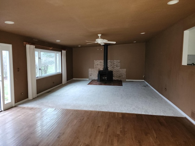 1122 Foster Ave, Lake Bluff, IL 60044 - unfurnished living room with wood finished floors, a wood stove, baseboards, and recessed lighting