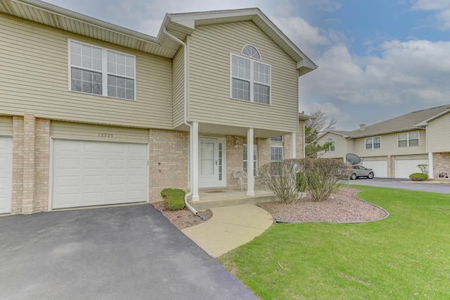 12525 S Central Park Ave, Alsip, IL 60803 - view of front facade with a garage, brick siding, a front lawn, driveway, and a porch