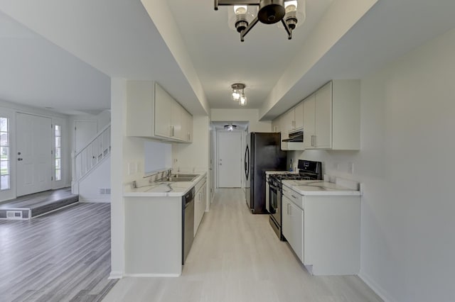 12525 S Central Park Ave, Alsip, IL 60803 - kitchen with light countertops, ventilation hood, light wood finished floors, dishwashing machine, and gas range