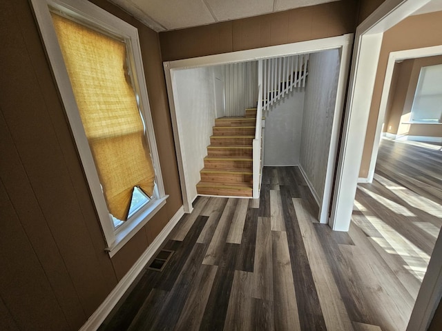 staircase featuring visible vents and wood finished floors