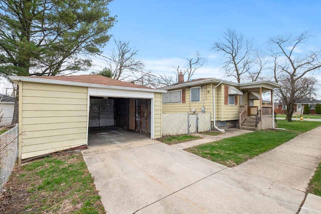 674 Memorial Dr, Calumet City, IL 60409 - view of front of property with a garage, a chimney, fence, an outbuilding, and driveway