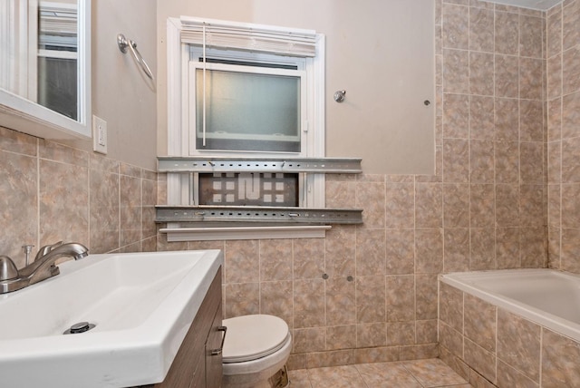 674 Memorial Dr, Calumet City, IL 60409 - full bath with tile patterned floors, toilet, a bath, tile walls, and a sink
