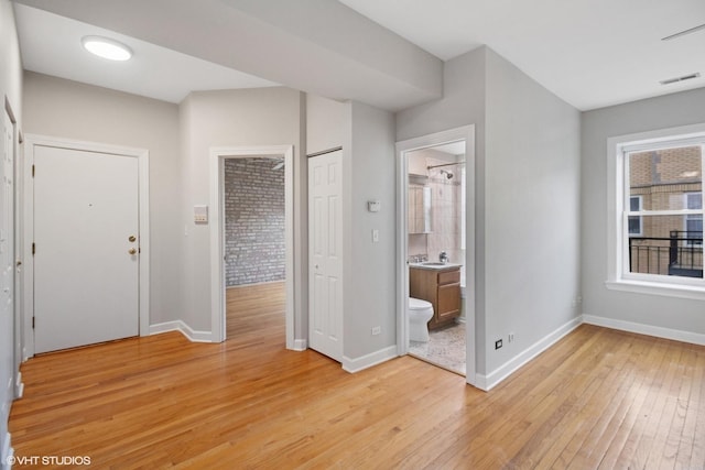 entrance foyer featuring light wood-style flooring, baseboards, and visible vents