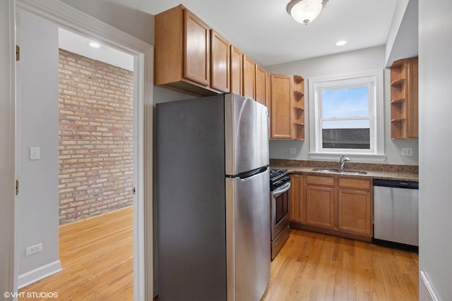 kitchen featuring a sink, stainless steel appliances, dark countertops, and open shelves