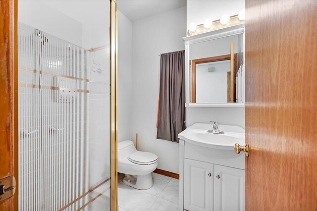 3338 S Bell Ave, Chicago, IL 60608 - bathroom featuring toilet, vanity, a stall shower, and baseboards