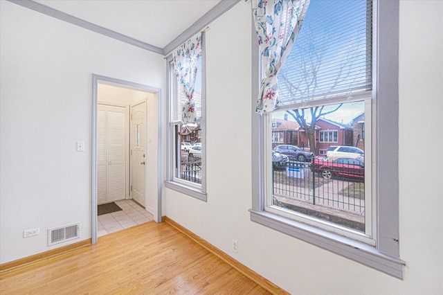 3338 S Bell Ave, Chicago, IL 60608 - empty room featuring wood finished floors, crown molding, baseboards, and visible vents