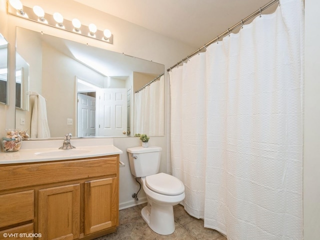full bathroom with toilet, vanity, and tile patterned floors