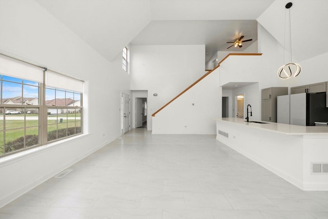 286 Sunset Blvd, Beecher, IL 60401 - unfurnished living room with a sink, visible vents, ceiling fan, and stairs