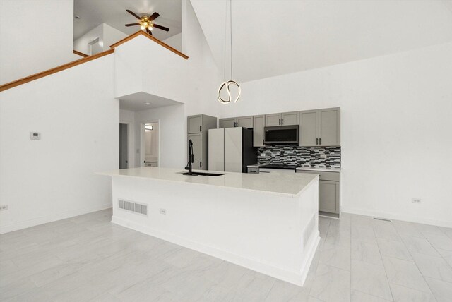 286 Sunset Blvd, Beecher, IL 60401 - kitchen featuring freestanding refrigerator, visible vents, stainless steel microwave, light countertops, and gray cabinetry
