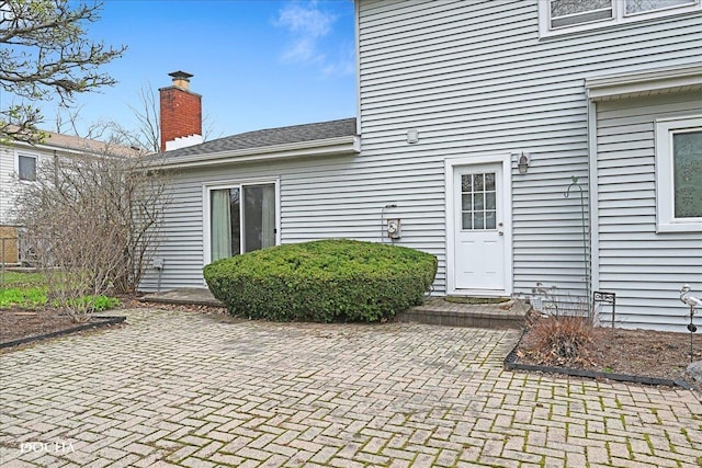 6914 Richmond Ave, Darien, IL 60561 - doorway to property featuring a chimney and a patio area
