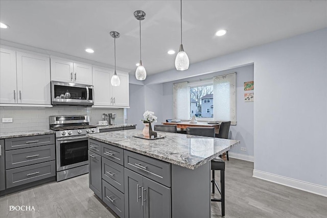 6914 Richmond Ave, Darien, IL 60561 - kitchen featuring white cabinets, stainless steel appliances, gray cabinets, and tasteful backsplash