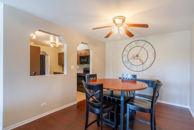 1505 E Central Rd Unit 211B, Arlington Heights, IL 60005 - dining area with a ceiling fan, dark wood-type flooring, arched walkways, and baseboards