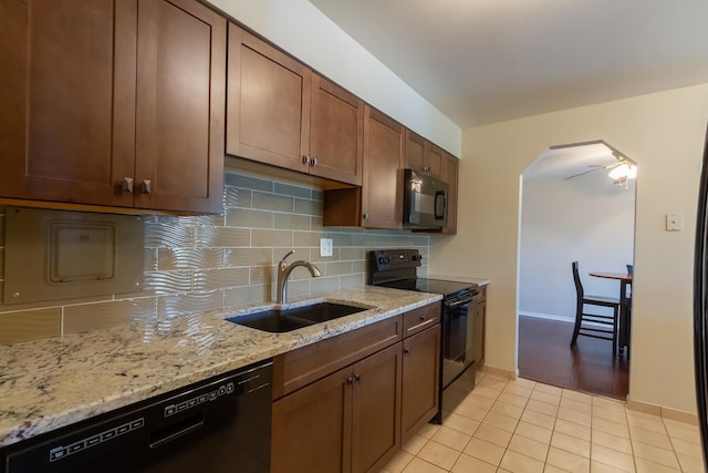 1505 E Central Rd Unit 211B, Arlington Heights, IL 60005 - kitchen with black appliances, a sink, backsplash, light tile patterned floors, and light stone countertops