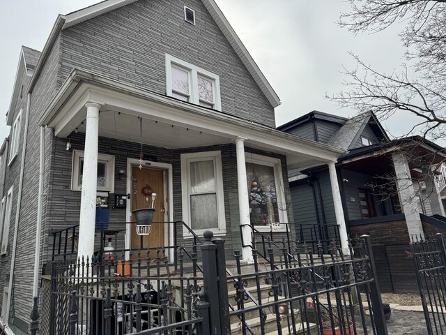 4221 N Sawyer Ave, Chicago, IL 60618 - view of front of home featuring a fenced front yard and covered porch